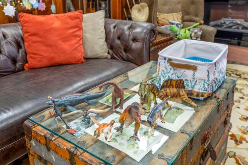 a chest with dinosaur figurines on it next to a couch at Best Western Denver Southwest in Lakewood