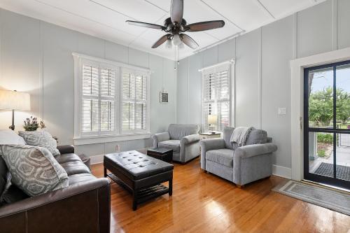 a living room with a couch and chairs and a ceiling fan at Ms. Bunny's Bungalow in Fredericksburg