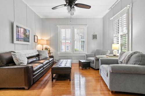 a living room with couches and a ceiling fan at Ms. Bunny's Bungalow in Fredericksburg