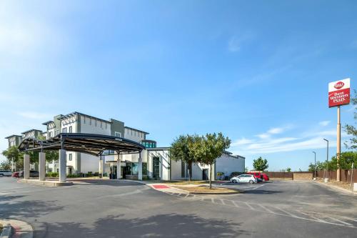 an empty parking lot with a gas station at Best Western Plus Lackland Hotel and Suites. in San Antonio