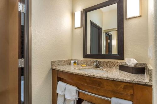 a bathroom with a sink and a mirror at Best Western Plus Lackland Hotel and Suites. in San Antonio