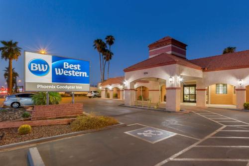 a hotel with a best western sign in a parking lot at Best Western Phoenix Goodyear Inn in Goodyear