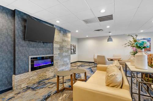 a waiting room with a couch and a fireplace at Best Western Plus Beckley Inn in Beckley