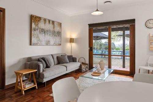 a living room with a couch and a table at Yarra Yering Homestead in Gruyere
