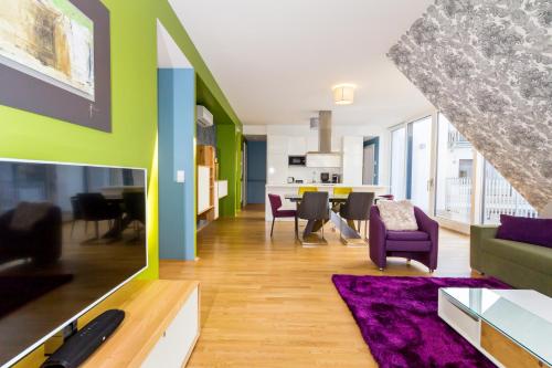 a living room with a couch and a dining room at VotivPark Vienna Serviced Apartments in Vienna