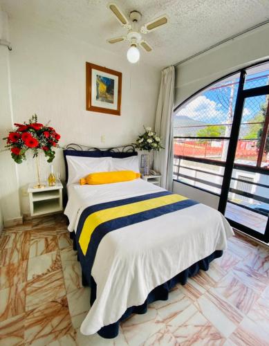 a bedroom with a bed and a large window at Hotel Presidente Vicente Guerrero in Chilpancingo de los Bravos