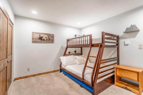 a bedroom with a bunk bed and a ladder at Wild Irishman #1030 by Summit County Mountain Retreats in Keystone
