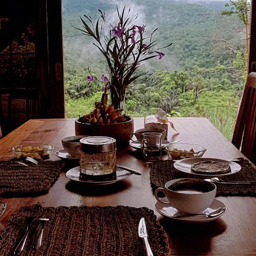 a wooden table with food on it with a view at Master Suite in Bukit Cottage in Noca