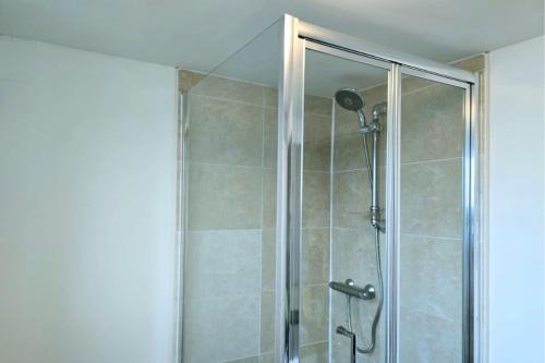a shower with a glass door in a bathroom at King Size City Centre En Suite Room with Parking in Preston