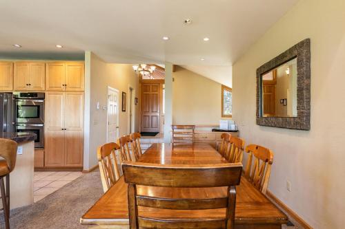 a kitchen and dining room with a wooden table and chairs at Eagles Nest by Tahoe Getaways - Pet Friendly with Hot Tub, Pool Table & Shuttle to Slopes in Olympic Valley
