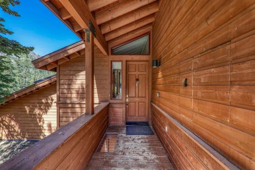 a wooden exterior of a house with a wooden door at Eagles Nest by Tahoe Getaways - Pet Friendly with Hot Tub, Pool Table & Shuttle to Slopes in Olympic Valley