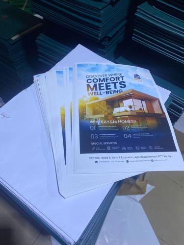 a stack of papers sitting on top of a table at Kay&M Homes LLC in Abuja