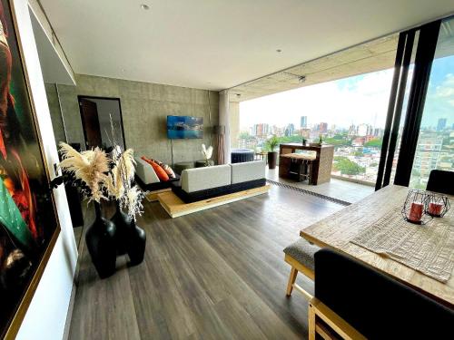 a living room with a couch and a table at Espectacular diseño, terraza con Hamaca y Jacuzzi in Guadalajara