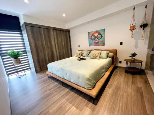 a bedroom with a large bed in a room at Espectacular diseño, terraza con Hamaca y Jacuzzi in Guadalajara