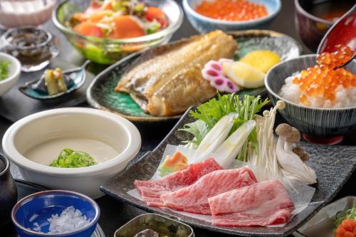 a table topped with different types of food in bowls at シーサイド佐竹 in Kyotango