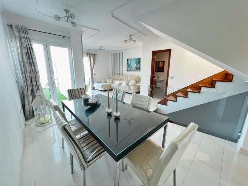 a dining room and living room with a table and chairs at Maravillosas vistas y el mejor clima del mundo! in La Playa de Arguineguín