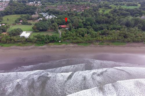 an aerial view of a beach with a red flag at Hotel Playa Bejuco in Esterillos Este