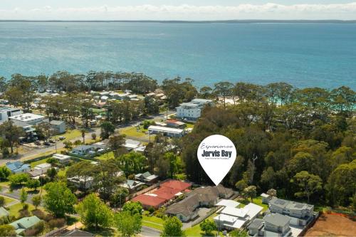 an aerial view of a town with a large white sign at White Sands Villa by Experience Jervis Bay in Huskisson