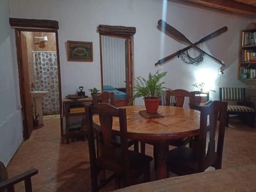 a dining room with a wooden table and chairs at Monte Guesthouse in Puerto Libertad