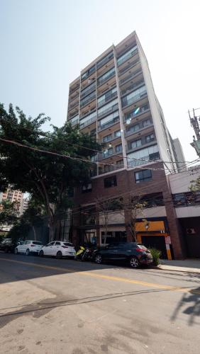 a large building with cars parked in front of it at Apezinho Moema in Sao Paulo