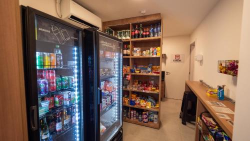 a refrigerator filled with lots of food and drinks at Apezinho Moema in Sao Paulo