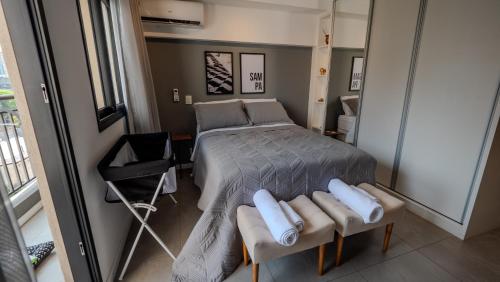a bedroom with a bed and a mirror at Apezinho Moema in Sao Paulo