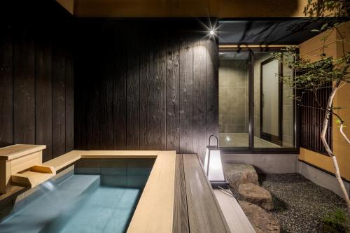 a swimming pool in the middle of a house at ROJIYU Kyoto in Kyoto