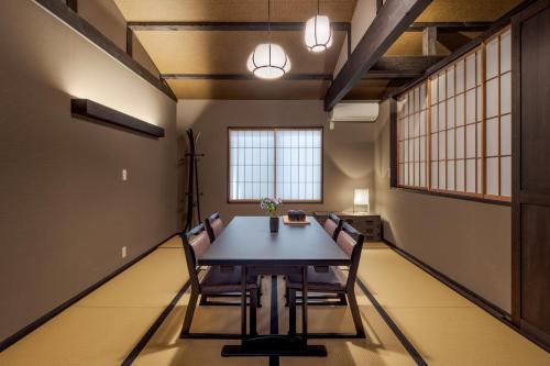 a dining room with a table and chairs at ROJIYU Kyoto in Kyoto
