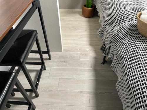 a wooden floor in a room with a table and a chair at COMMA HOUSE Otsuka 4-1 in Tokyo