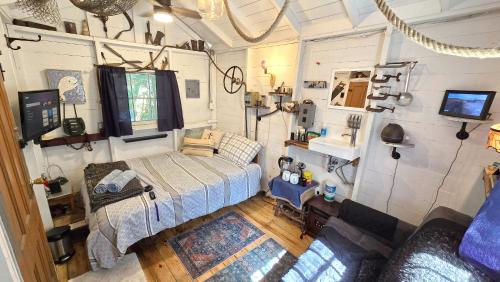 an overhead view of a bedroom in a tiny house at The Stabbin Cabin on Grant Island, Brantingham Lake - HotTub, Boat, Pet Friendly in Glenfield