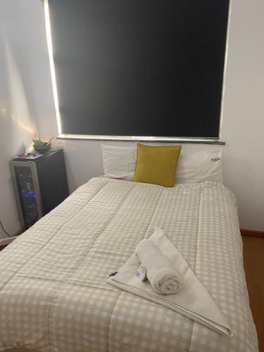 a bed with two towels on top of it at Granten Palaces in Summerstrand