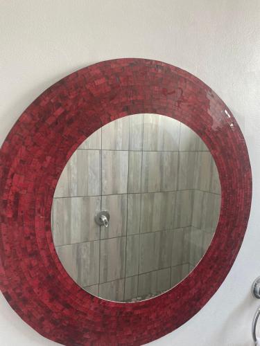 a red brick mirror hanging on a wall at Granten Palaces in Summerstrand
