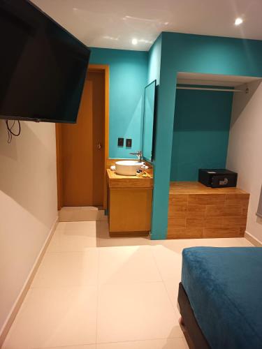Ένα ή περισσότερα κρεβάτια σε δωμάτιο στο Hotel Kavia Mazatlán