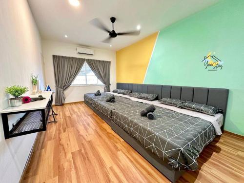 a bedroom with a large bed and a table at Kampung8 17pax Snooker Arcade in Melaka