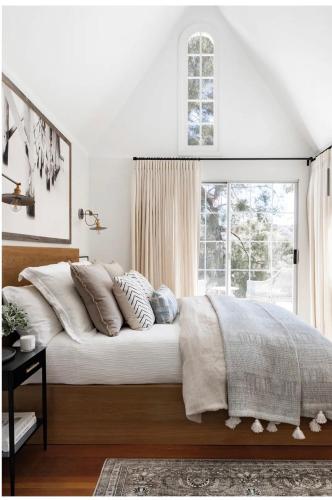 a bedroom with a bed with pillows and a window at Zen Treehouse Retreat-Great Views & Peaceful Decks in Los Angeles