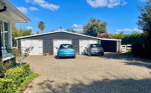 two cars parked in front of a garage at Pa Road B&B Kerikeri NZ in Kerikeri