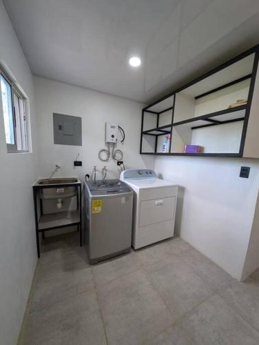 a kitchen with a sink and a washing machine at Villa Jalapa "4x4 is Needed" in San Luis