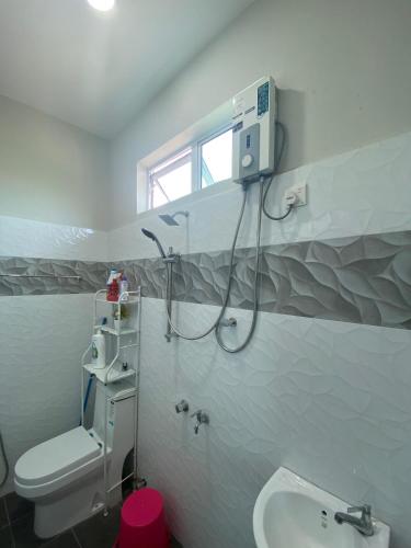 a bathroom with a shower and a toilet and a sink at Homestay Tok Ma 2 Gong Chempedak Marang in Marang