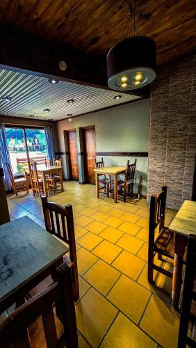 a restaurant with wooden tables and chairs and a dining room at Constantino Hostel by lo de Guille in El Chalten
