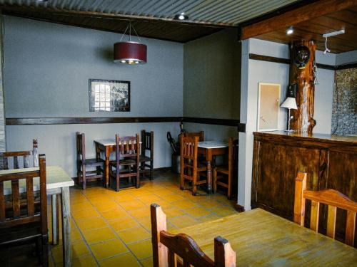 a dining room with tables and chairs in a restaurant at Constantino Hostel by lo de Guille in El Chalten