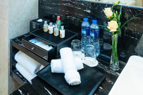 a bathroom with a black counter with towels and water bottles at Crowne Plaza Xi'an by IHG in Xi'an