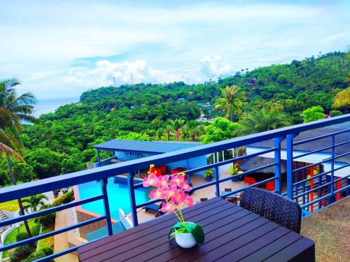 a balcony with a table and a view of the ocean at AV Suites in Puerto Galera