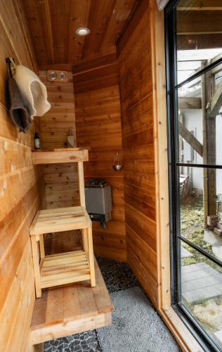 a wooden cabin with a sauna with a window at Urban Nest Guest House in Charlotte