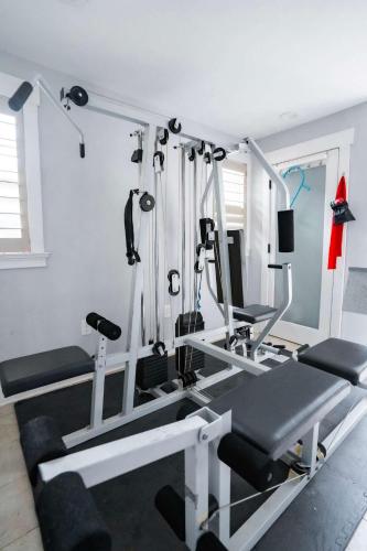 a room with a gym with tread machines at Urban Nest Guest House in Charlotte