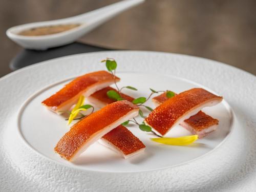 a white plate with three pieces of food on it at InterContinental Shenzhen WECC by IHG in Shenzhen