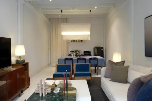 a living room with a couch and a table at Nap by Snooze in Bangkok