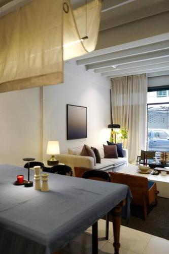 a living room with a couch and a table at Nap by Snooze in Bangkok