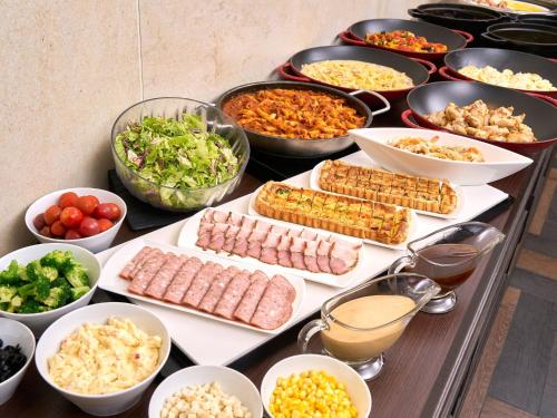 a table topped with lots of different types of food at Hotel Villa Fontaine Kobe Sannomiya in Kobe