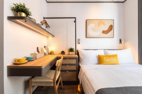 a bedroom with a desk and a bed at Dash Living on Queen's in Hong Kong