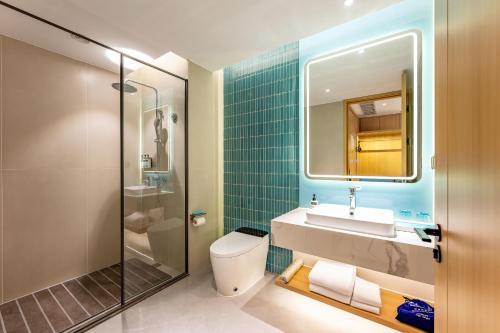 a bathroom with a toilet and a sink and a shower at Holiday Inn Express Nanjing Xi'anmen by IHG in Nanjing